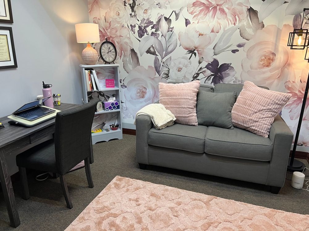 Sheri's therapy office with floral wallpaper and cozy sofa
